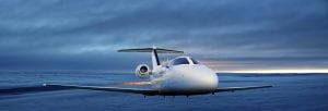 Executive private jet flying above the clouds at sunset