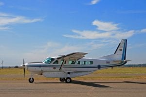 A Cessna Caravan aeroplane taxiing along the runway