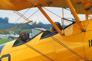 pilot sat in front of co-pilot in a biplane